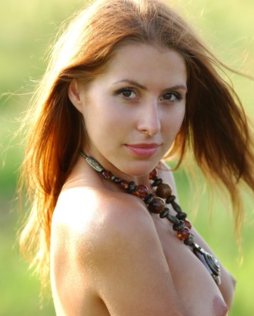 Sexy redhead girl is hunting at the field