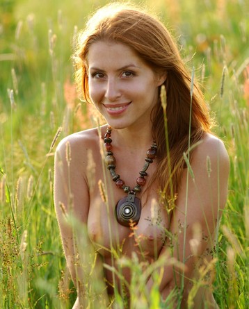 Sexy redhead girl is hunting at the field